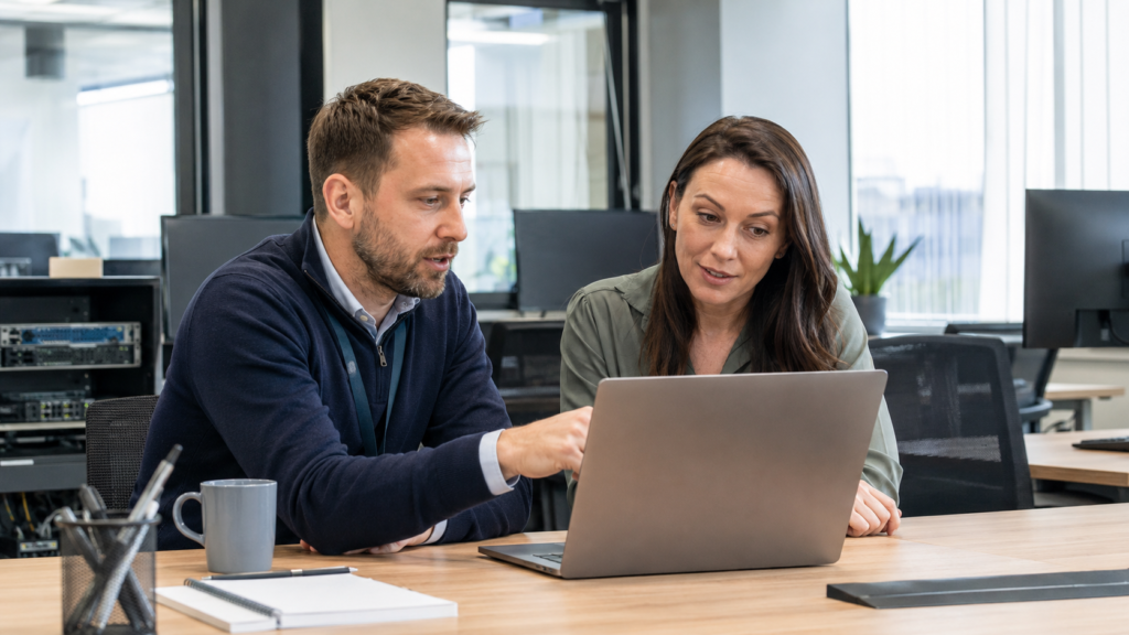Cyber security specialist reviewing business security settings with a small business owner