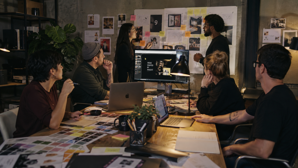 Creative agency team discussing campaign ideas in a studio